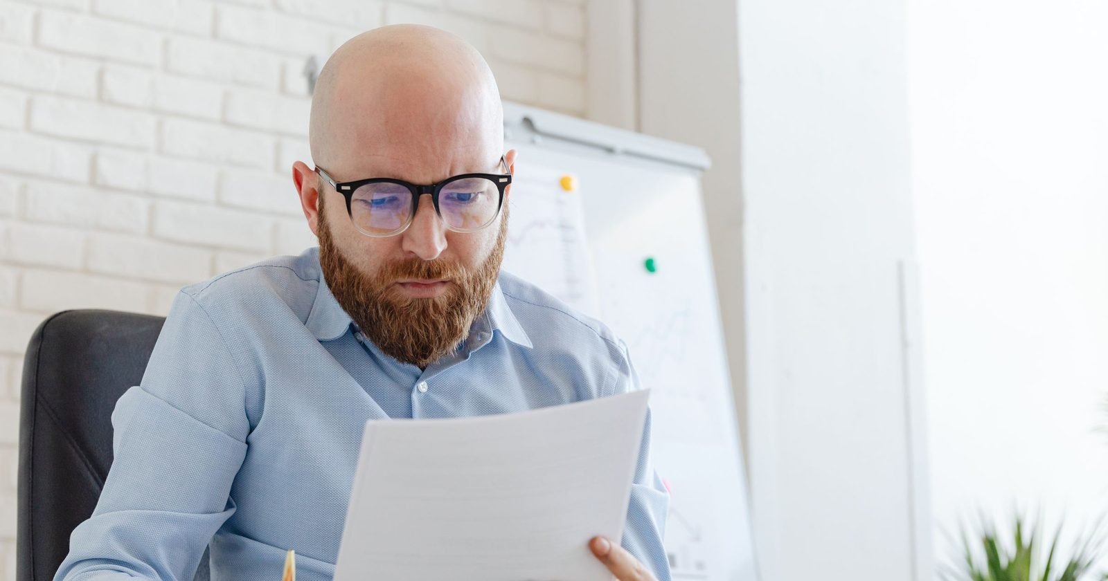 Professional carefully checking a document at their desk